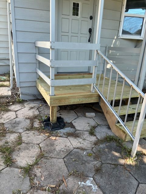 New pressure-treated porch landing and steps with railing in Pinellas Park, FL